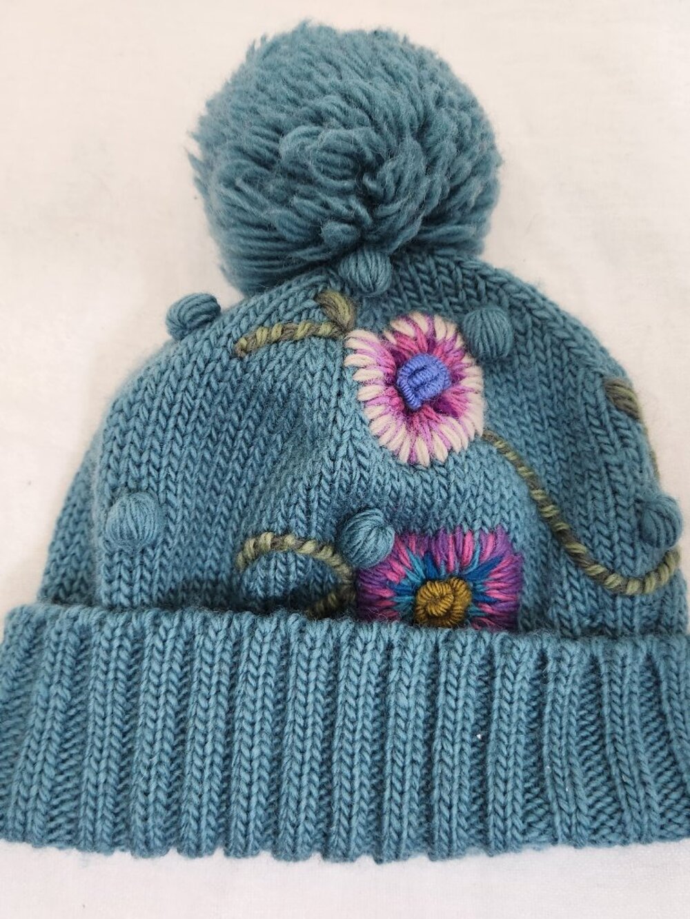Lost Horizons Womens 100% Wool Blue Knit Beautiful Embroidered Floral Pom Beanie